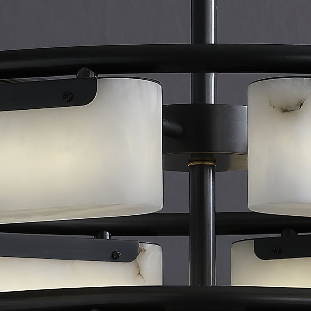 Close view of the Clérachic alabaster ring chandelier hub, where a brass collar meets the matte black stem between the two tiers.