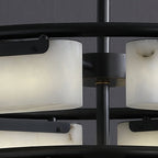 Close view of the Clérachic alabaster ring chandelier hub, where a brass collar meets the matte black stem between the two tiers.