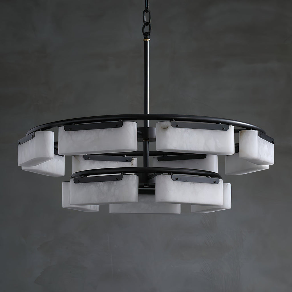 The Clérachic Two-Tier Alabaster Ring Chandelier unlit against a grey plaster wall, showing its stacked ring silhouette.
