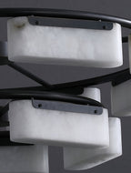 Detail of the Clérachic alabaster ring chandelier, each stone shade held by a brushed metal strap screwed to the black frame.