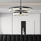 Clérachic Two-Tier Alabaster Ring Chandelier lit low over a black leather sofa in a pale panelled living room.