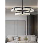 Clérachic alabaster ring chandelier lit in a living room, glowing above a linen sofa beside a dark latticed screen.