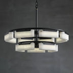 The Clérachic Two-Tier Alabaster Ring Chandelier lit against a dark charcoal wall, twelve alabaster shades glowing softly.