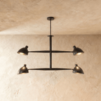 Clérachic chandelier in matte black, four cone shades on a crossbar frame beneath a plaster ceiling.