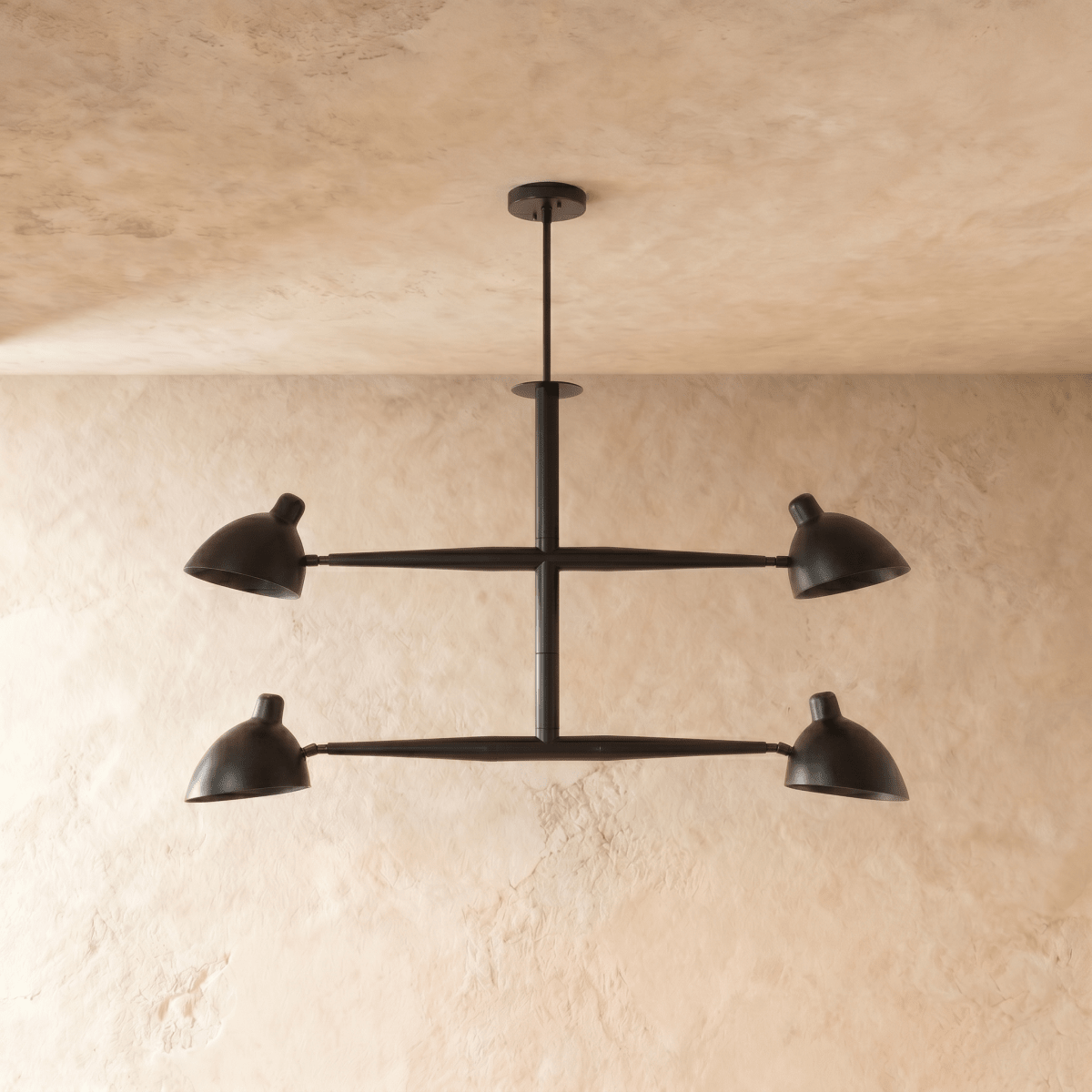Clérachic chandelier in matte black shown from another angle, its crossbar arms catching soft light.