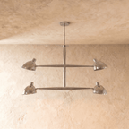 Clérachic chandelier in chrome shown from another angle, its crossbar arms catching a metallic sheen.