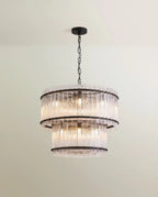Clérachic two-tier chandelier with a matte black frame, chain and canopy, wrapped in fluted clear glass rods.