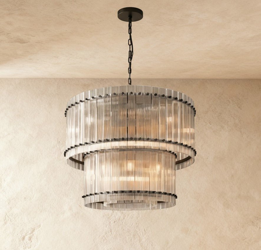Clérachic two-tier chandelier in matte black with fluted clear glass rods and round black studs, hung on a black chain.
