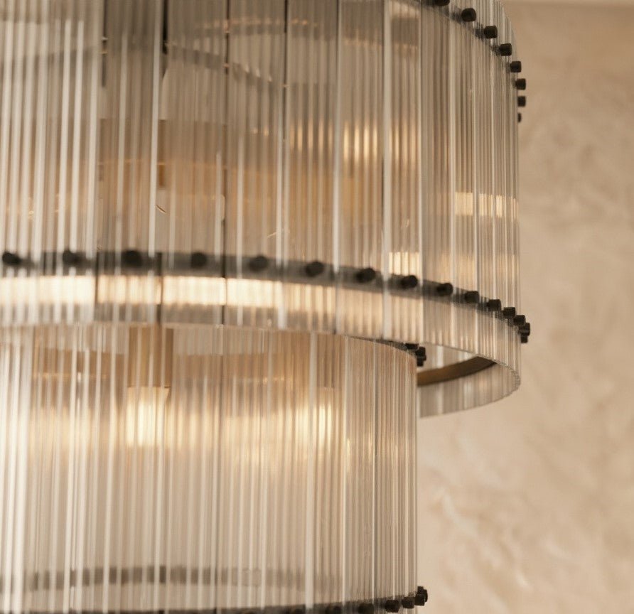 Clérachic close view of fluted clear glass rods and black studs on the two tiers of the matte black chandelier.