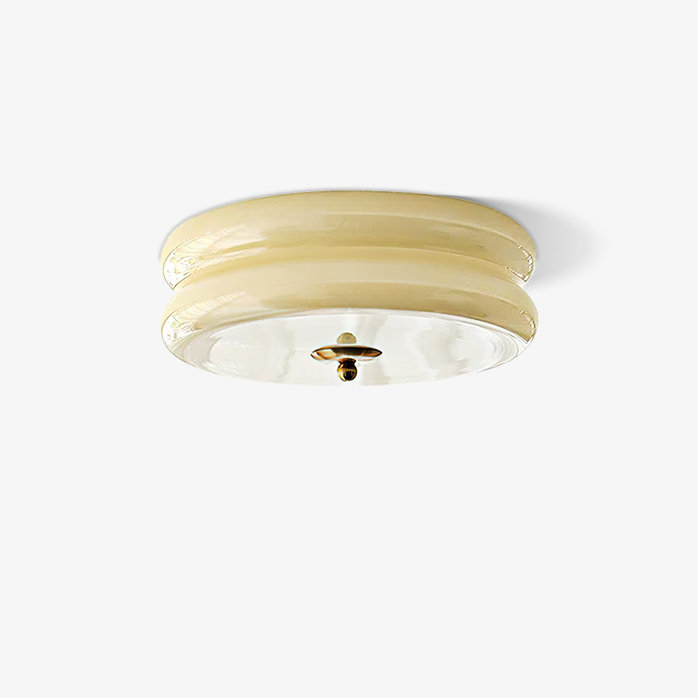 Studio view of the Clérachic two-tier flush mount ceiling light in beige glass with a gold finial on a white ground.