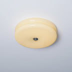 Clérachic two-tier flush mount ceiling light in cream glass, unlit, with its chrome finial seen from below and to the side.