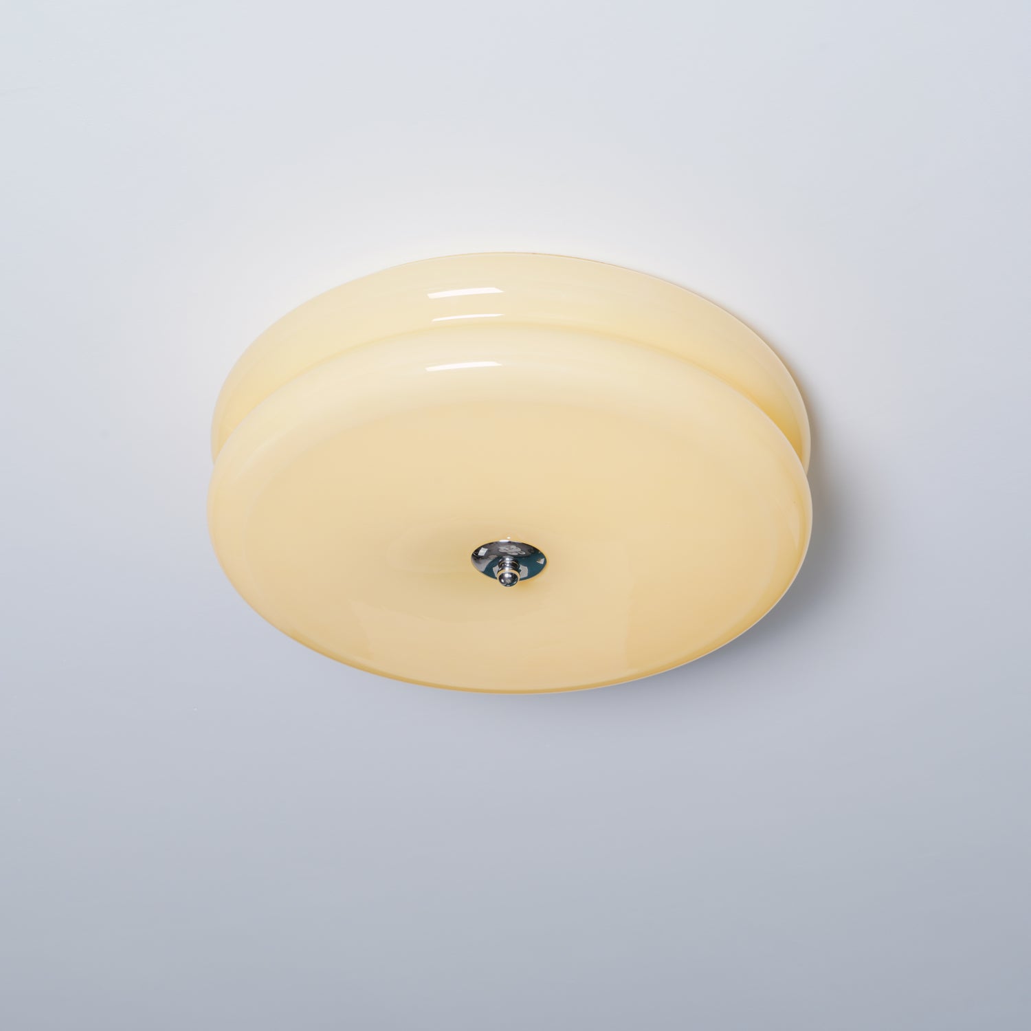 Clérachic two-tier flush mount ceiling light in cream glass, unlit, with its chrome finial seen from below and to the side.