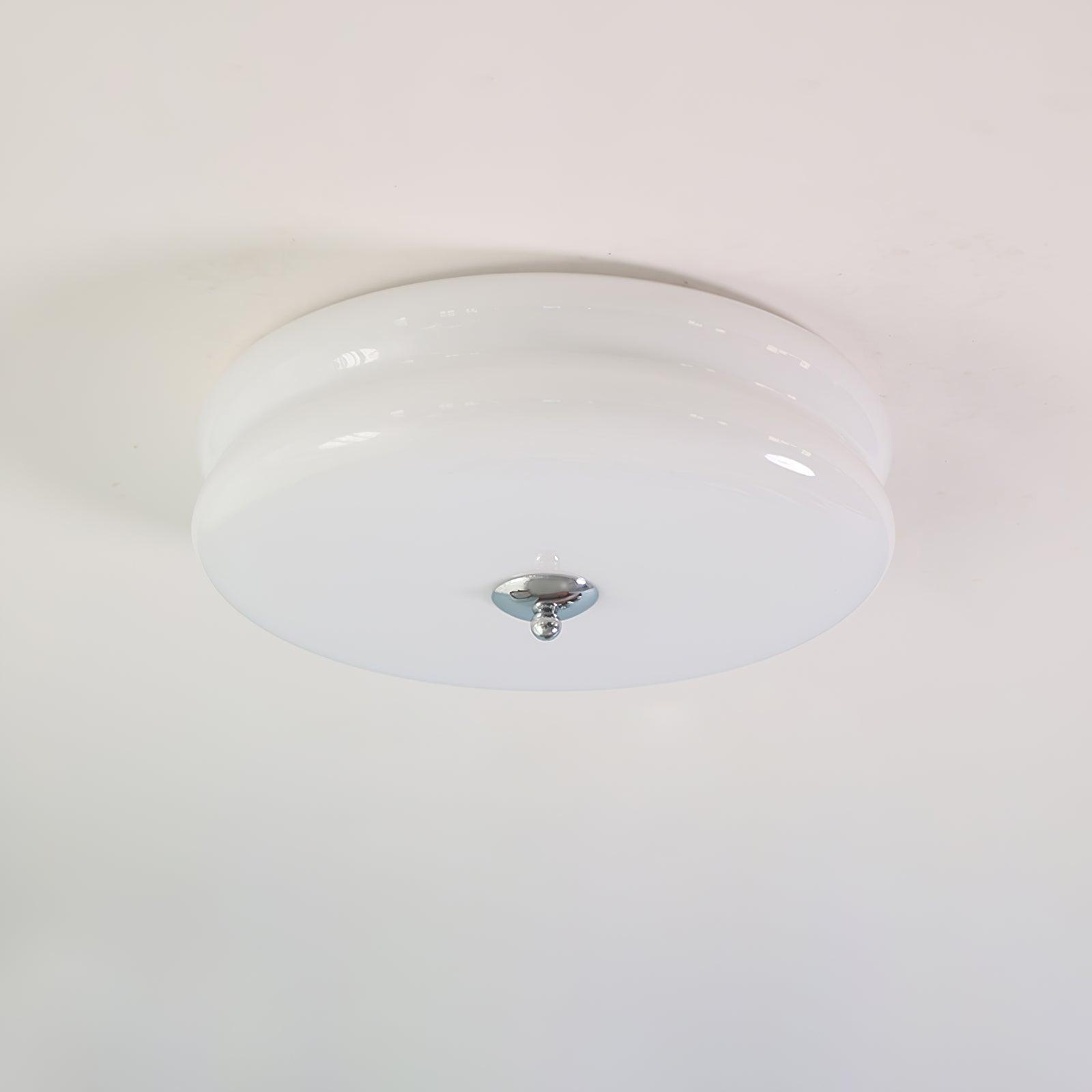 White opal Clérachic two-tier flush mount ceiling light seen from below, chrome finial centred on the flat underside.