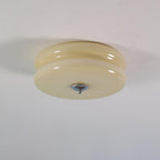 Cream glass Clérachic two-tier flush mount ceiling light fitted flat to a plaster ceiling, chrome finial pointing down.