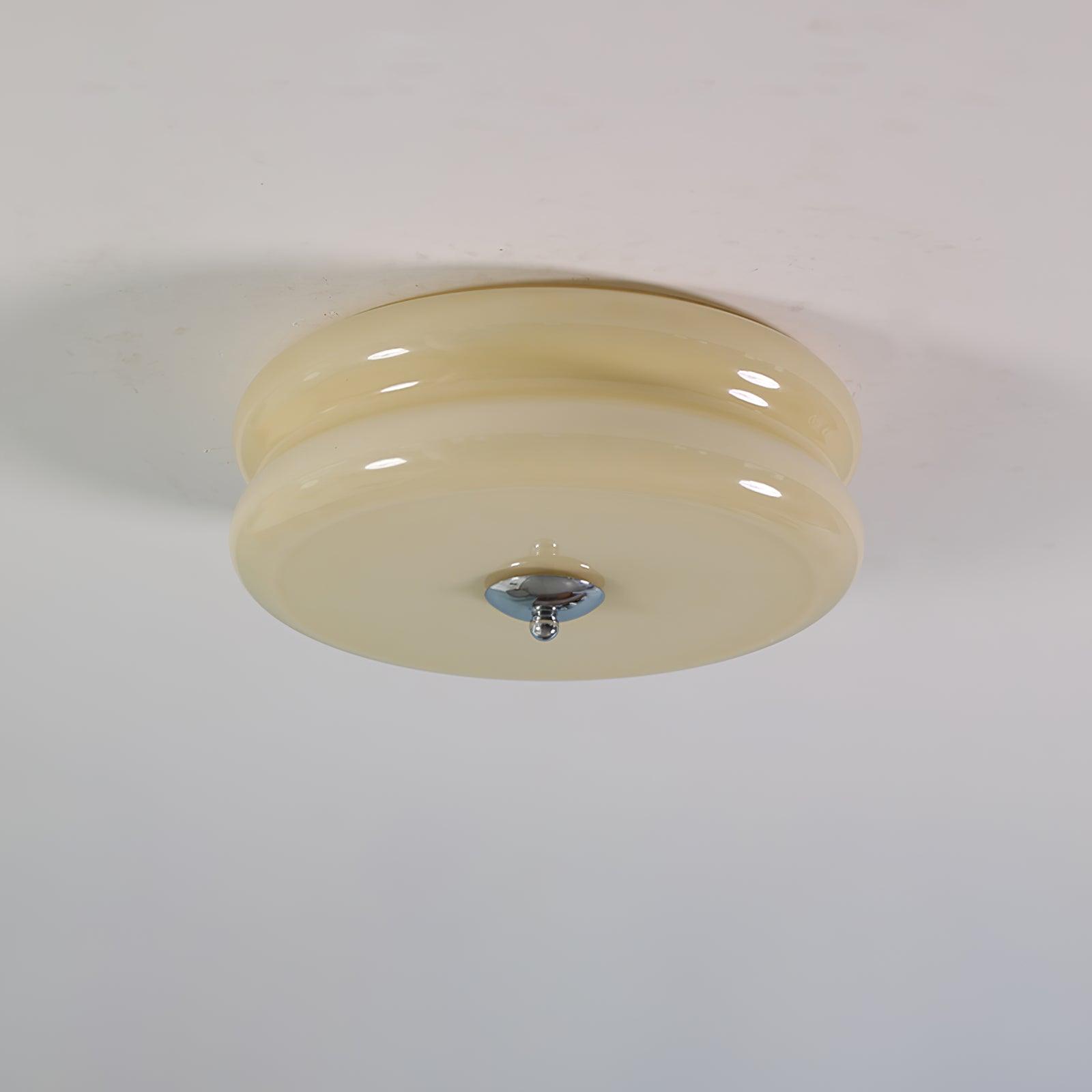 Cream glass Clérachic two-tier flush mount ceiling light fitted flat to a plaster ceiling, chrome finial pointing down.