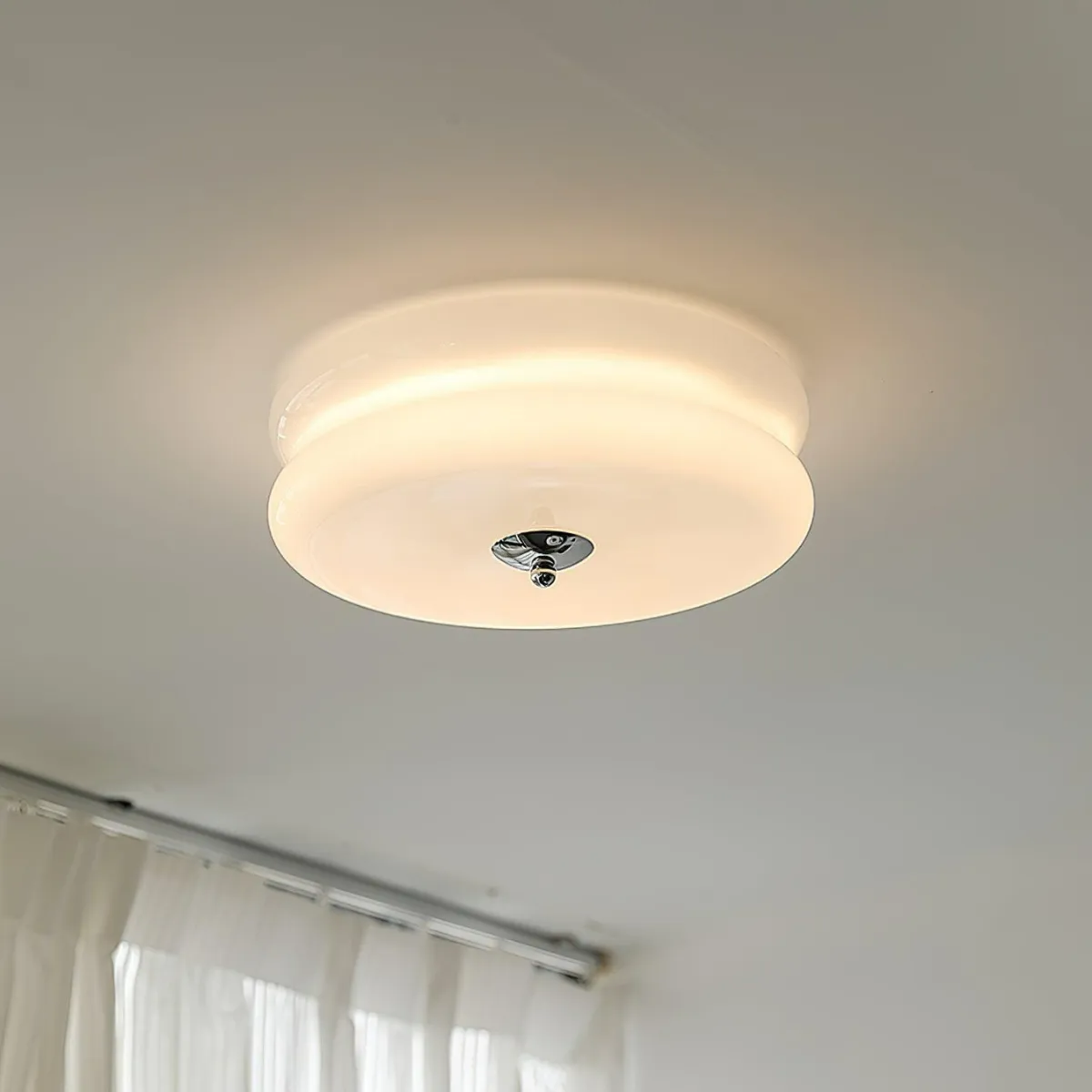 Clérachic two-tier flush mount ceiling light lit softly in white glass, chrome finial over a curtain track.