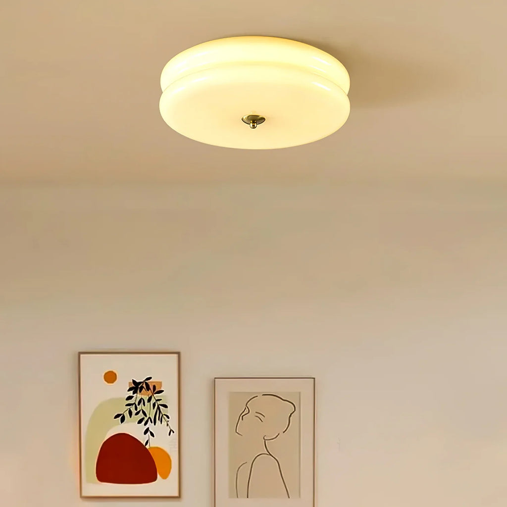 Clérachic two-tier flush mount ceiling light glowing over a hallway wall hung with two framed prints.