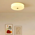 Clérachic two-tier flush mount ceiling light glowing over a hallway wall hung with two framed prints.