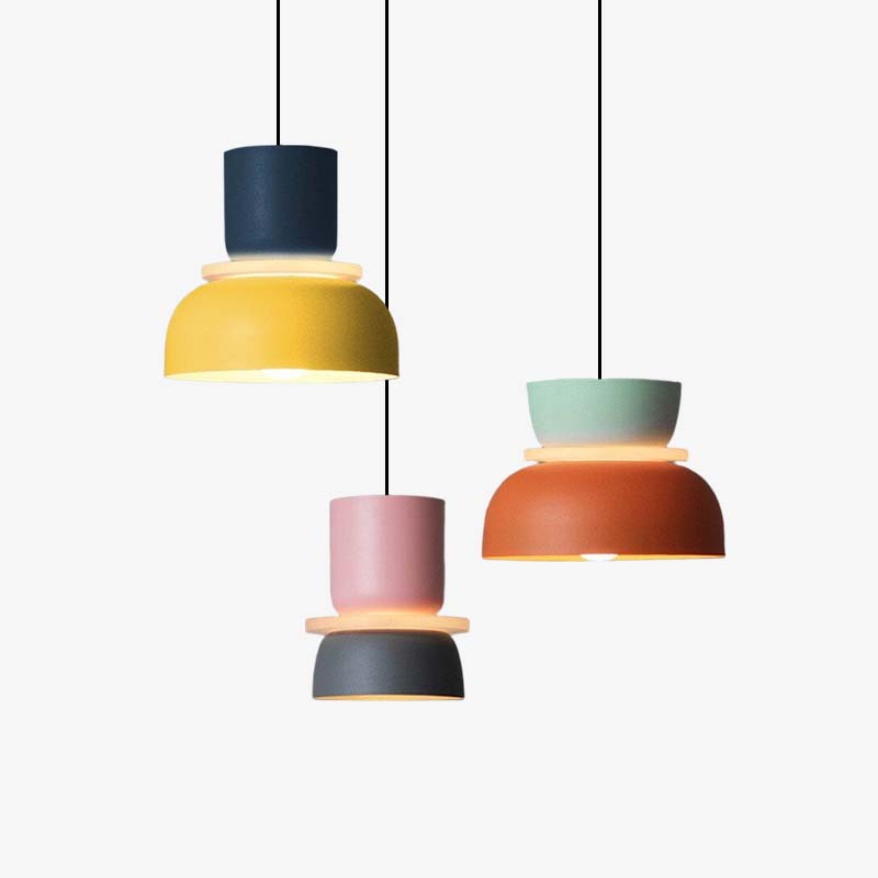 Three Clérachic two-tone dome pendants — navy-yellow, pink-charcoal and mint-orange — grouped on a plain backdrop.
