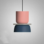 Studio shot of the Clérachic two-tone dome pendant in the Pink Blue colourway, dusty pink top over a navy blue dome.