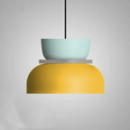 Studio shot of the Clérachic two-tone dome pendant in the Blue Yellow colourway, mint-blue top over a yellow dome.