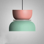 Studio shot of the Clérachic two-tone dome pendant in the Pink Green colourway, dusty pink top over a mint dome.
