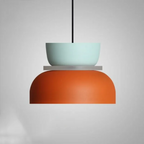 Studio shot of the Clérachic two-tone dome pendant in the Blue Orange colourway, mint-blue top over a rust dome.