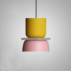 Studio shot of the Clérachic two-tone dome pendant in the Yellow Pink colourway, mustard top over a pink dome.