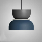 Studio shot of the Clérachic two-tone dome pendant in the Gray Blue colourway, charcoal top over a navy dome.