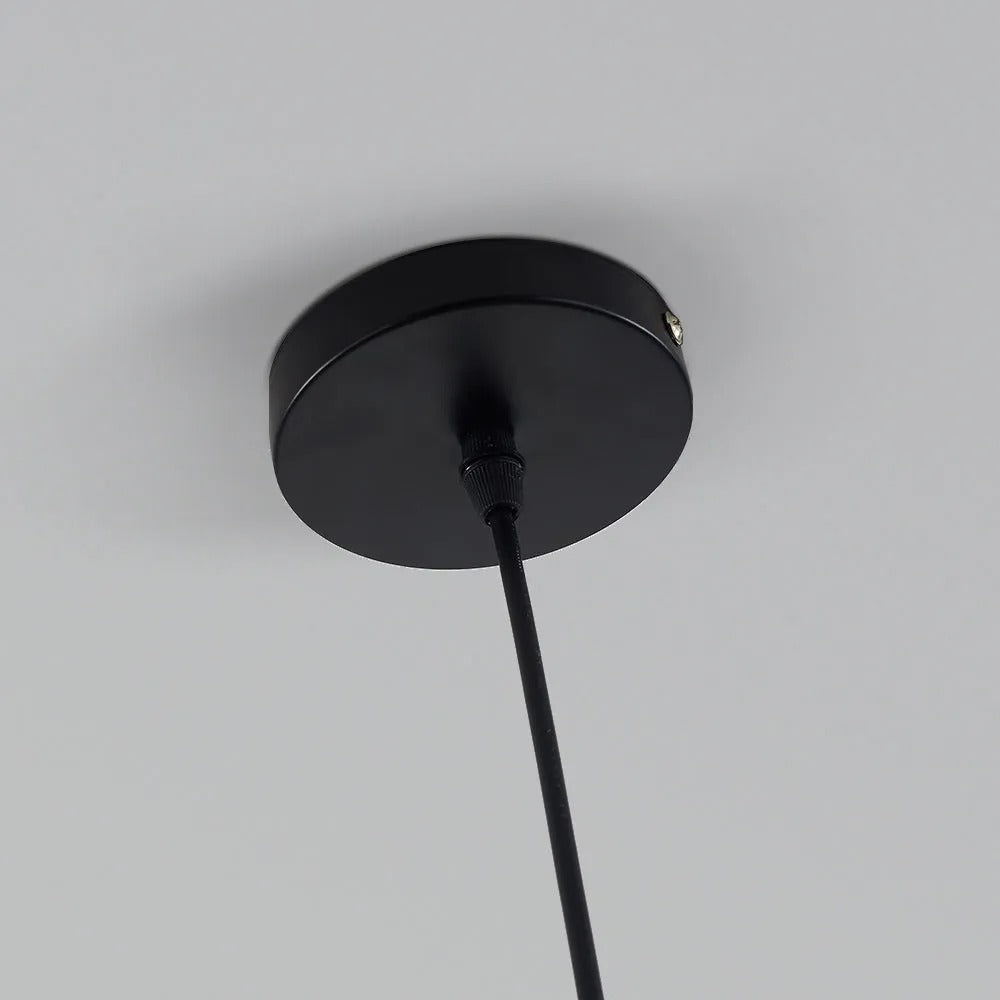 Close-up of the black ceiling canopy and cord on the Clérachic two-tone dome pendant, mounted on a plain wall.