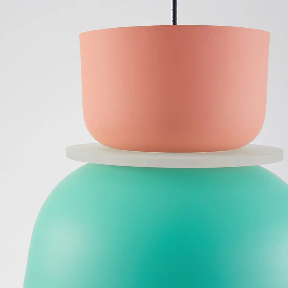 Close-up of the seam where the pink upper cup meets the mint lower dome on the Clérachic two-tone pendant light.