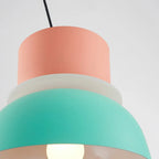 Close-up from below showing the glowing diffuser seam between the pink and mint sections of the Clérachic pendant.