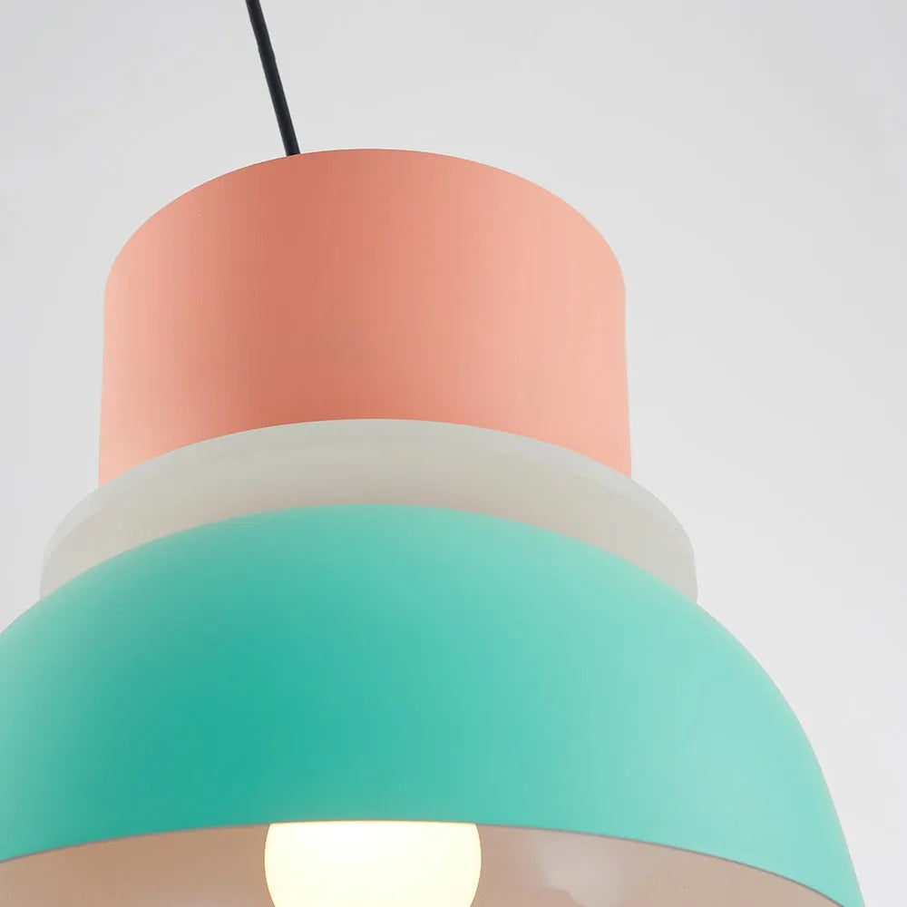 Close-up from below showing the glowing diffuser seam between the pink and mint sections of the Clérachic pendant.
