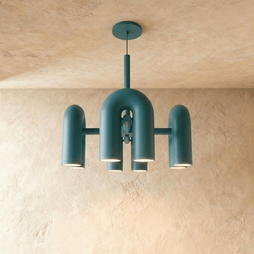 Clérachic chandelier of rounded U-shaped modules in deep blue, hanging below a round canopy in front of a limewashed plaster wall.