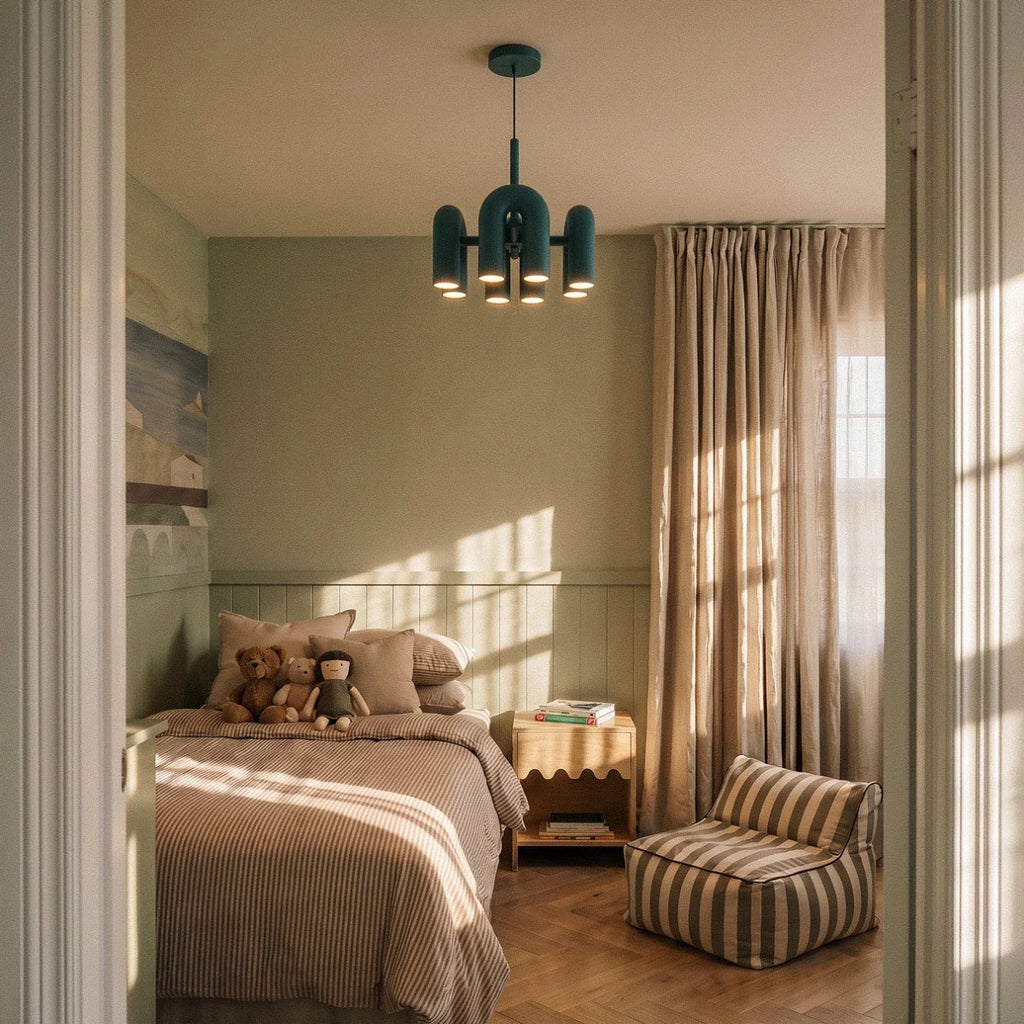 Clérachic blue arch-module chandelier hanging in a child's bedroom with sage panelling, linen curtains and a striped bed.