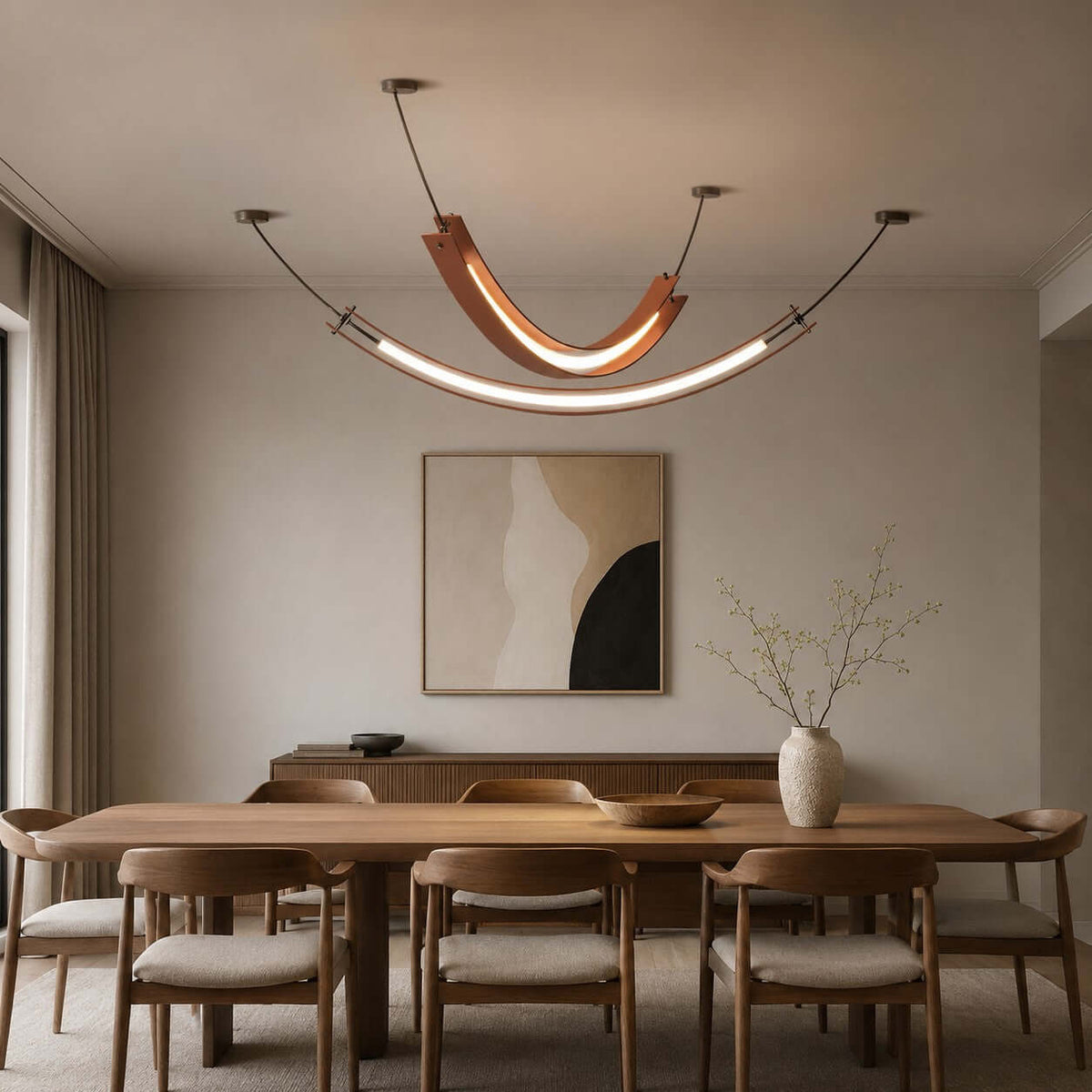 Terracotta U-shaped Clérachic pendant with a longer, slim lit strip hung below it, over a wooden dining table and a sideboard.