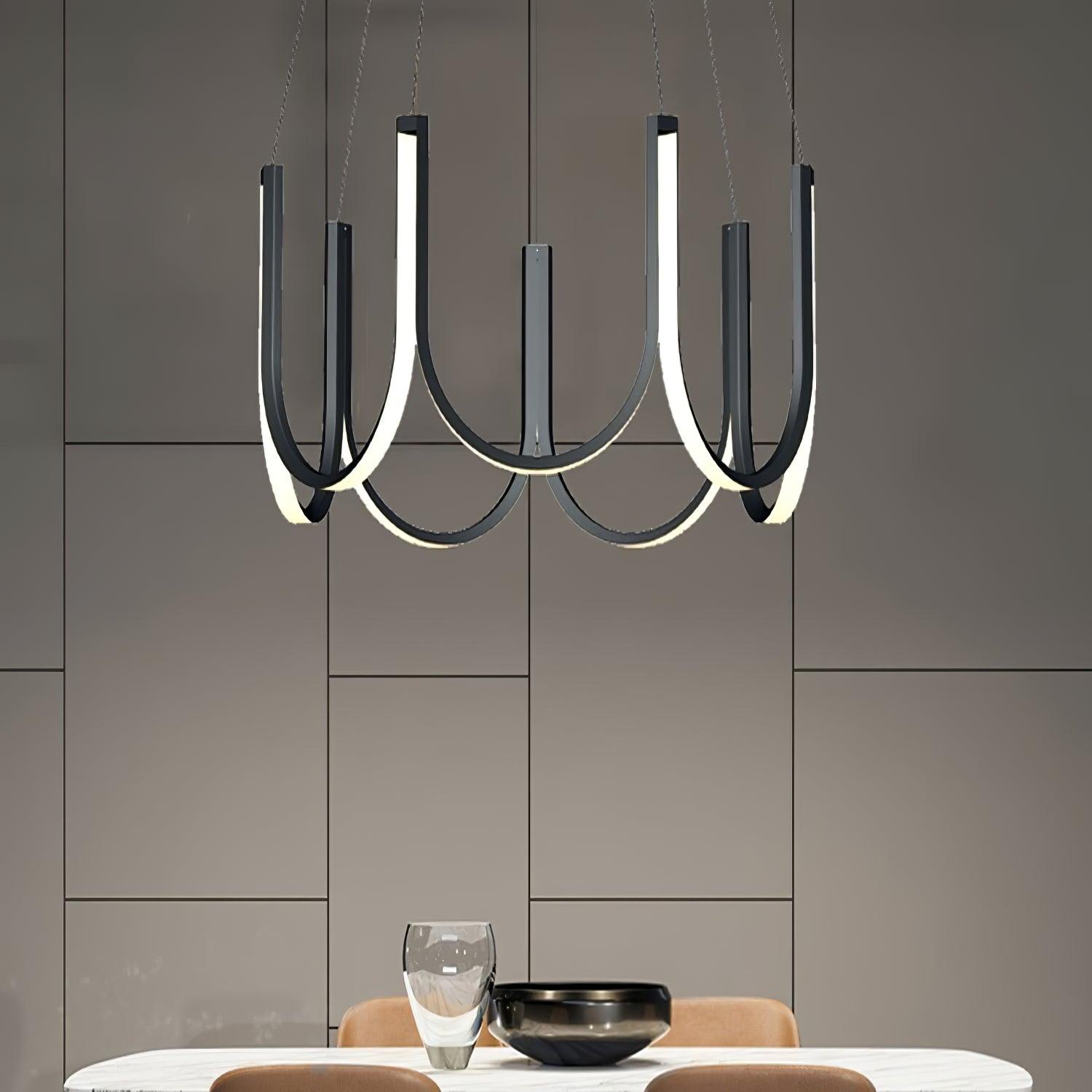 Clérachic looped arm pendant in black over a dining table against a panelled wall.