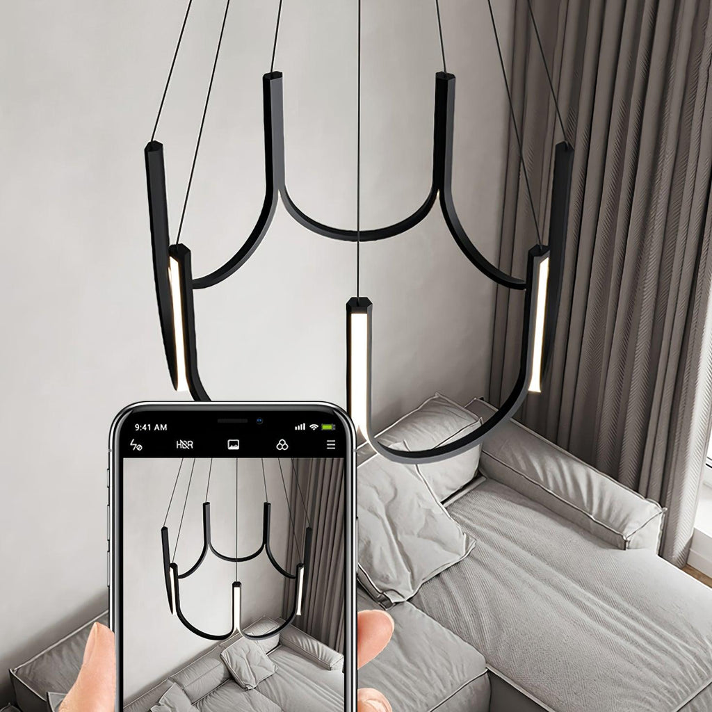 Clérachic looped arm pendant being photographed on a phone above a made bed.