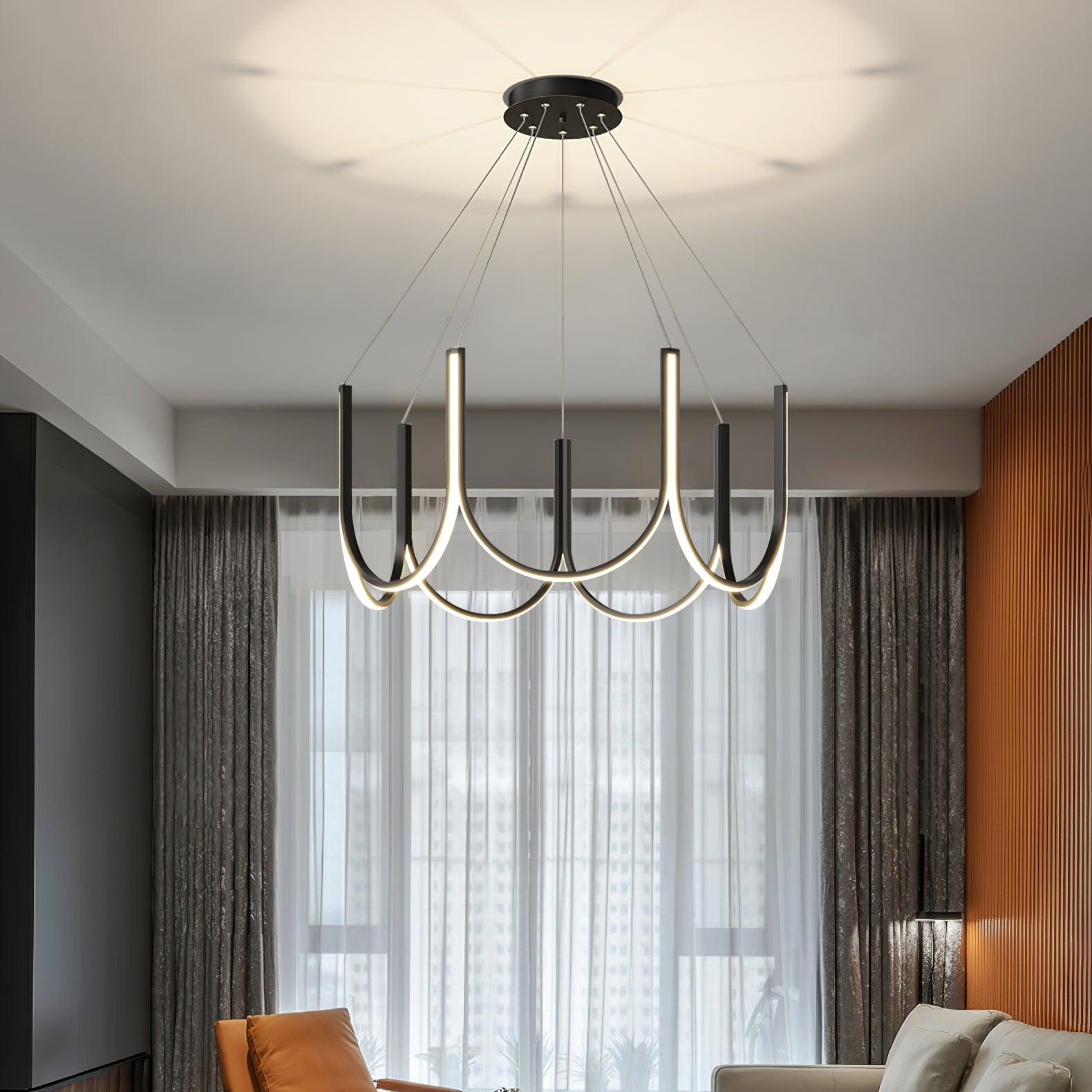 Clérachic looped arm pendant lit above a living room with sheer curtains and a city view.