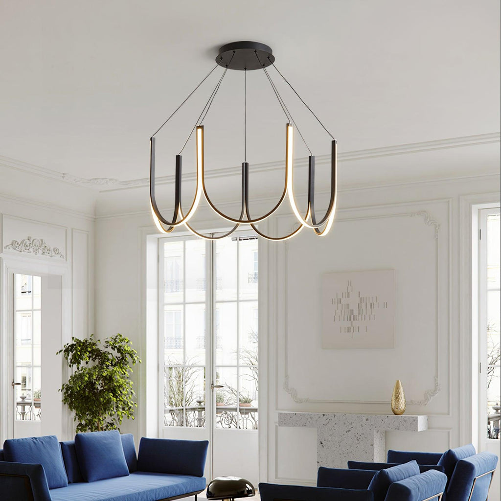 Clérachic looped arm pendant in a Parisian salon with blue sofas and tall windows.