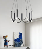 Clérachic looped arm pendant above a console holding a figurine and blue abstract canvas.