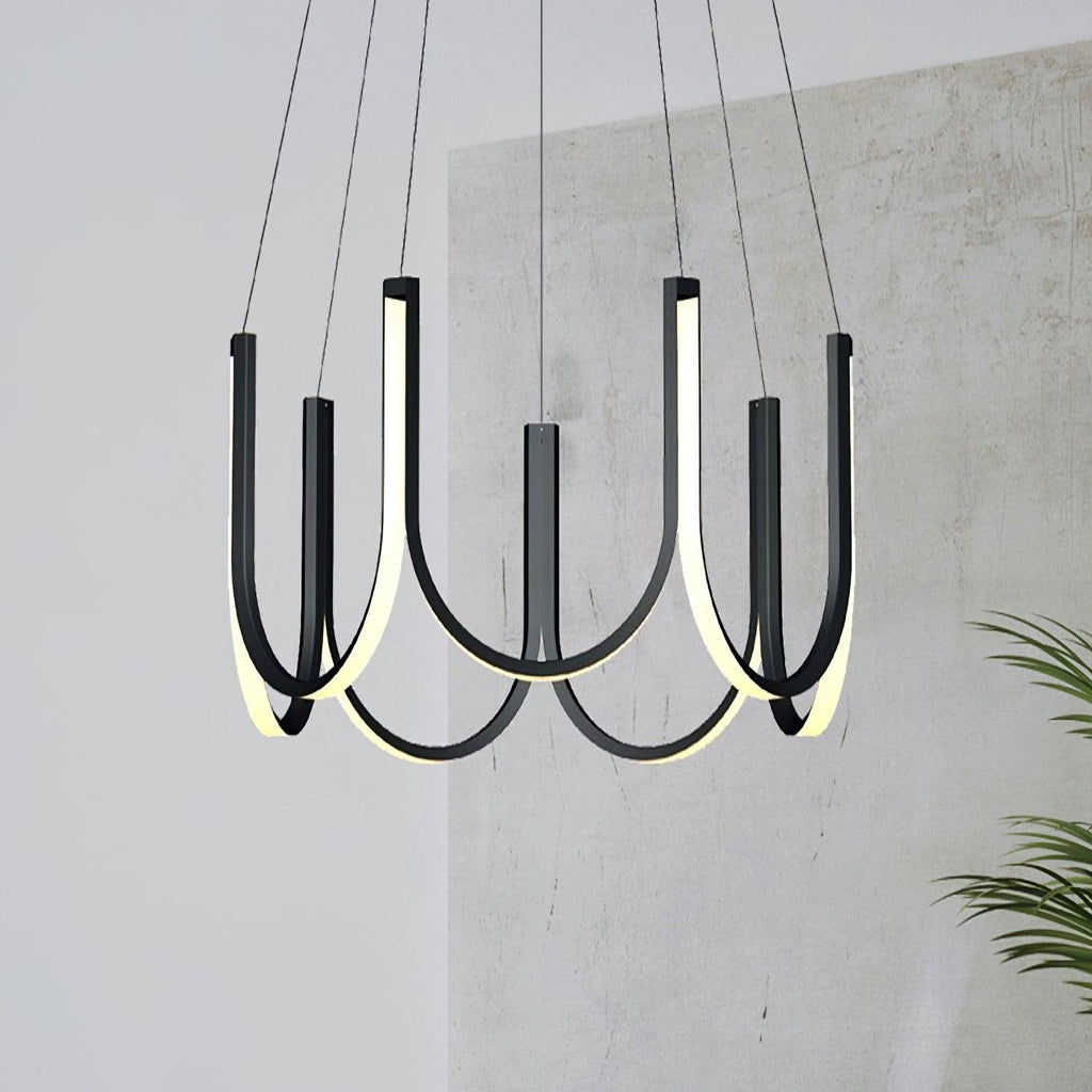 Clérachic looped arm pendant against a raw concrete wall beside a potted palm.