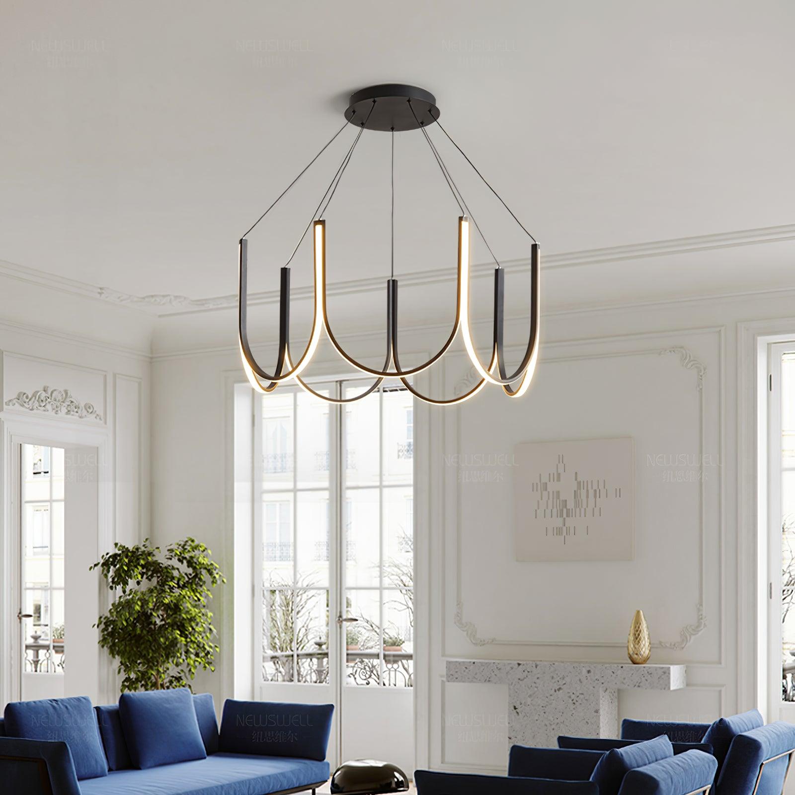 Clérachic looped arm pendant lit in a blue-furnished salon with panelled walls.