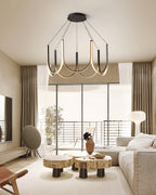 The Clérachic looped arm pendant in a large living room with full-height glazing.