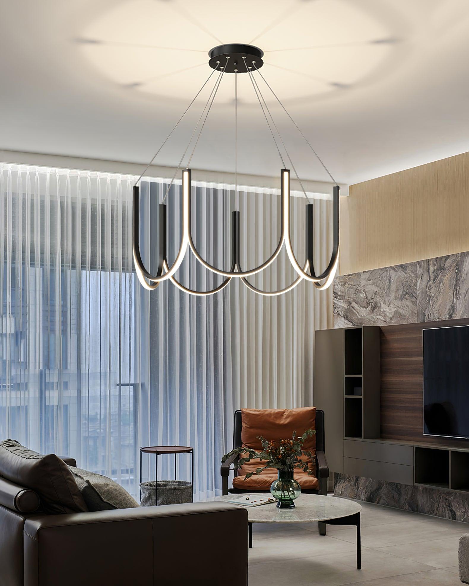 The Clérachic looped arm pendant above a leather sofa in a marble-walled living room.