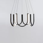 Clérachic looped arm pendant viewed from below, six lit loops fanning outward.