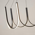 Close view of three Clérachic pendant loops, warm light running along the inner face.