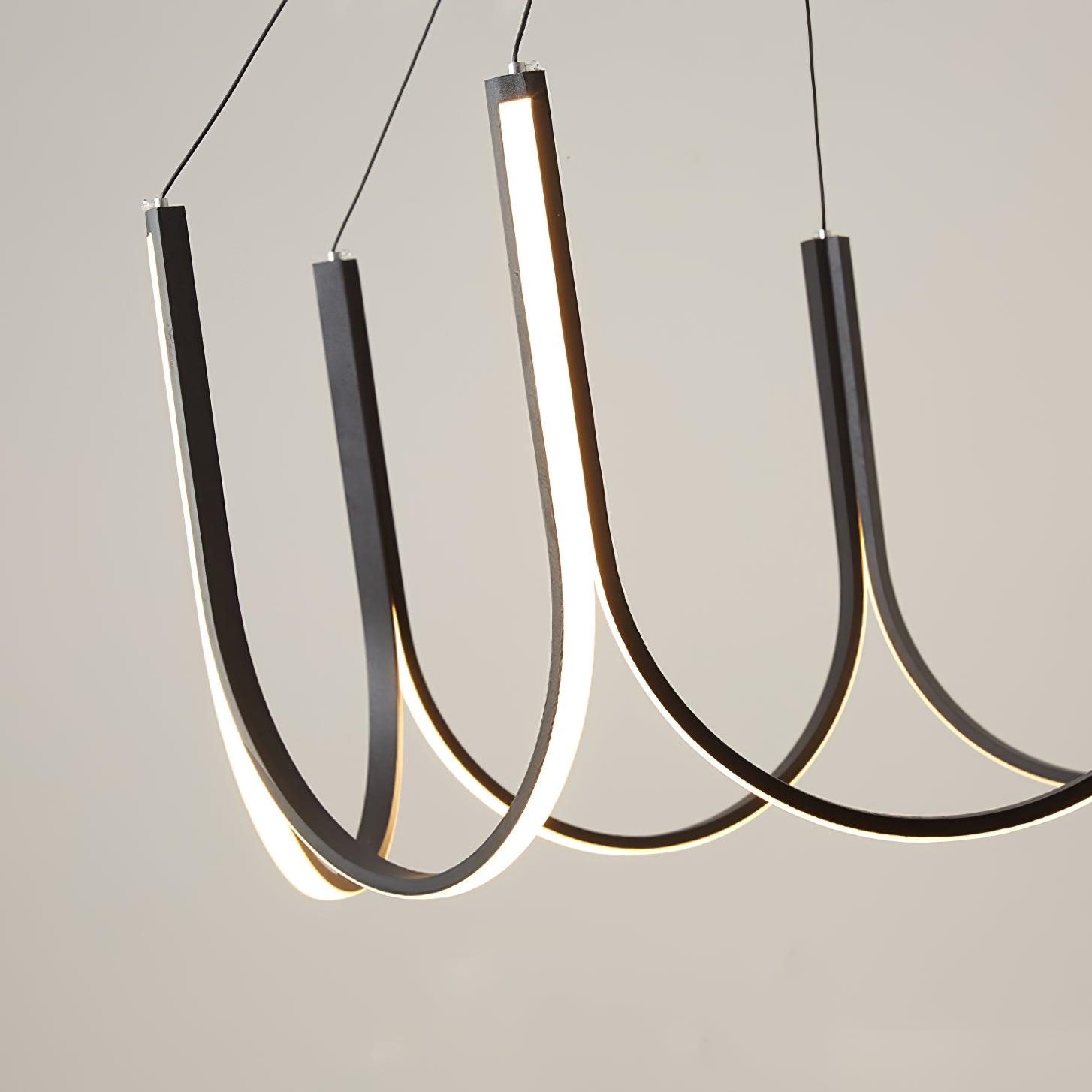 Close view of three Clérachic pendant loops, warm light running along the inner face.