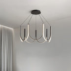 Clérachic looped arm pendant lit beside floor-length curtains in a soft grey room.