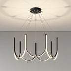 Clérachic looped arm pendant lit close under the ceiling, soft pools of light above.